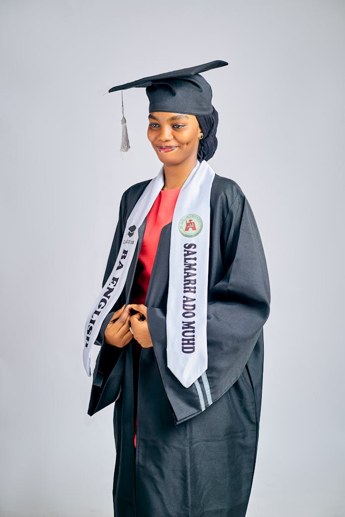 Portrait of a young graduate smiling in cap and gown, representing academic success and future aspirations.